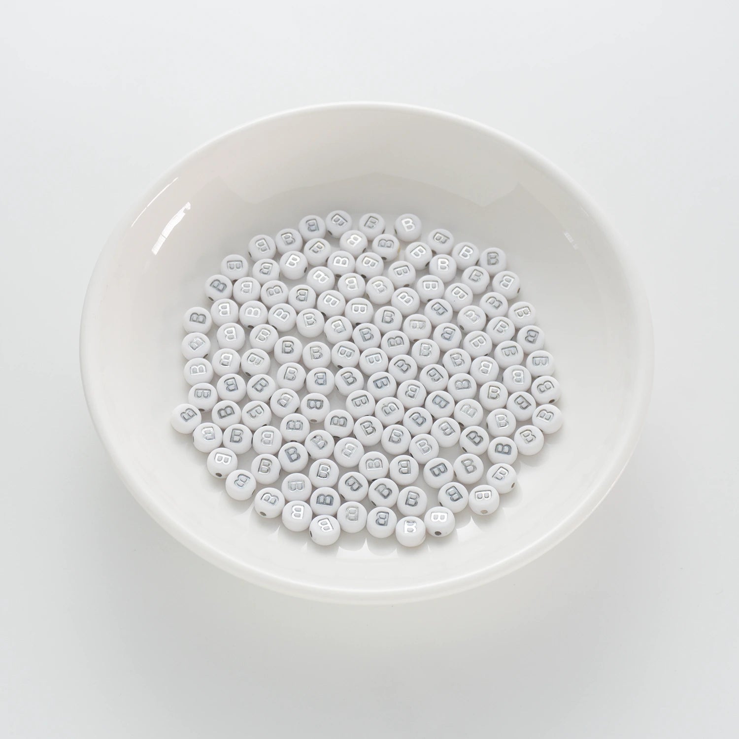 BD00085-01-silver-letter-white-opaque-coin-alphabet-beads-single-b-4×7mm