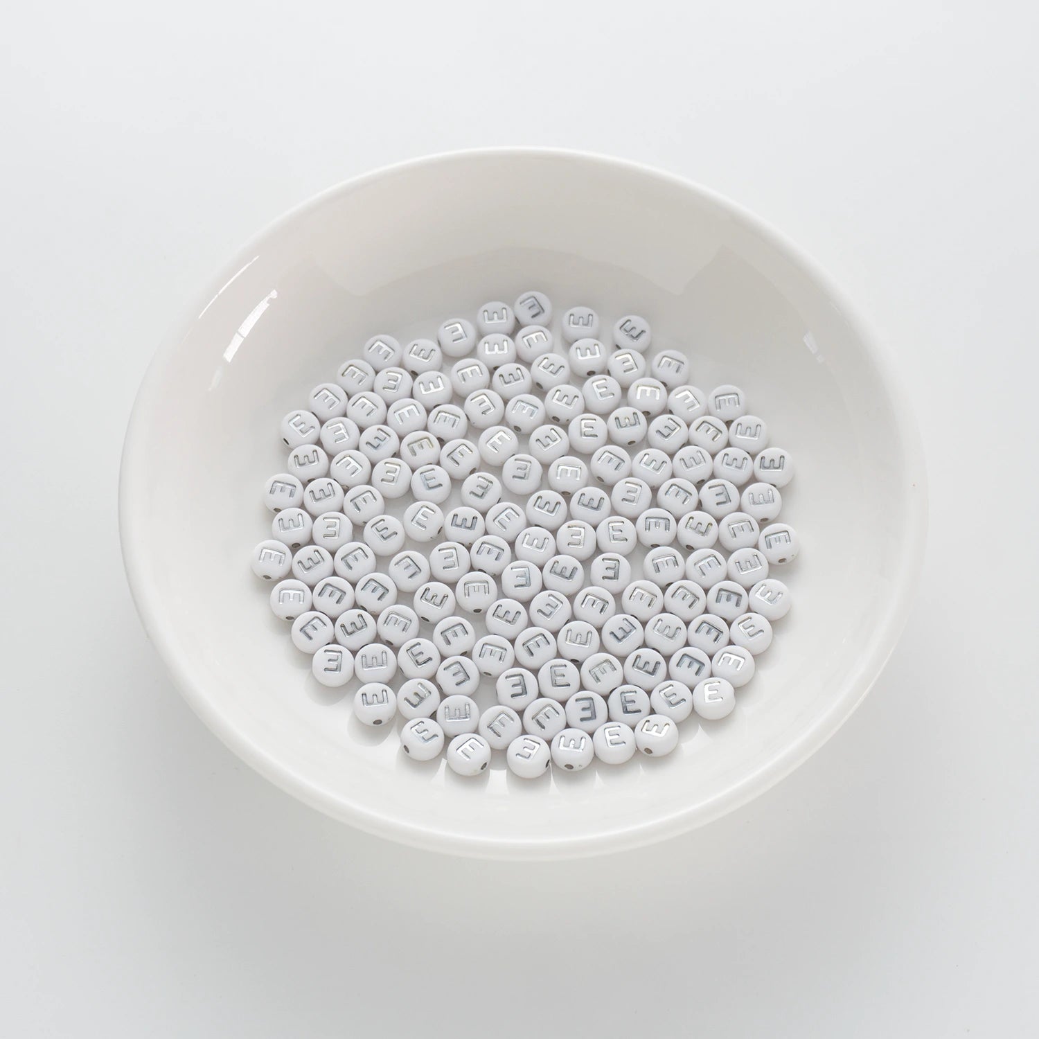 BD00088-01-silver-letter-white-opaque-coin-alphabet-beads-single-e-4×7mm