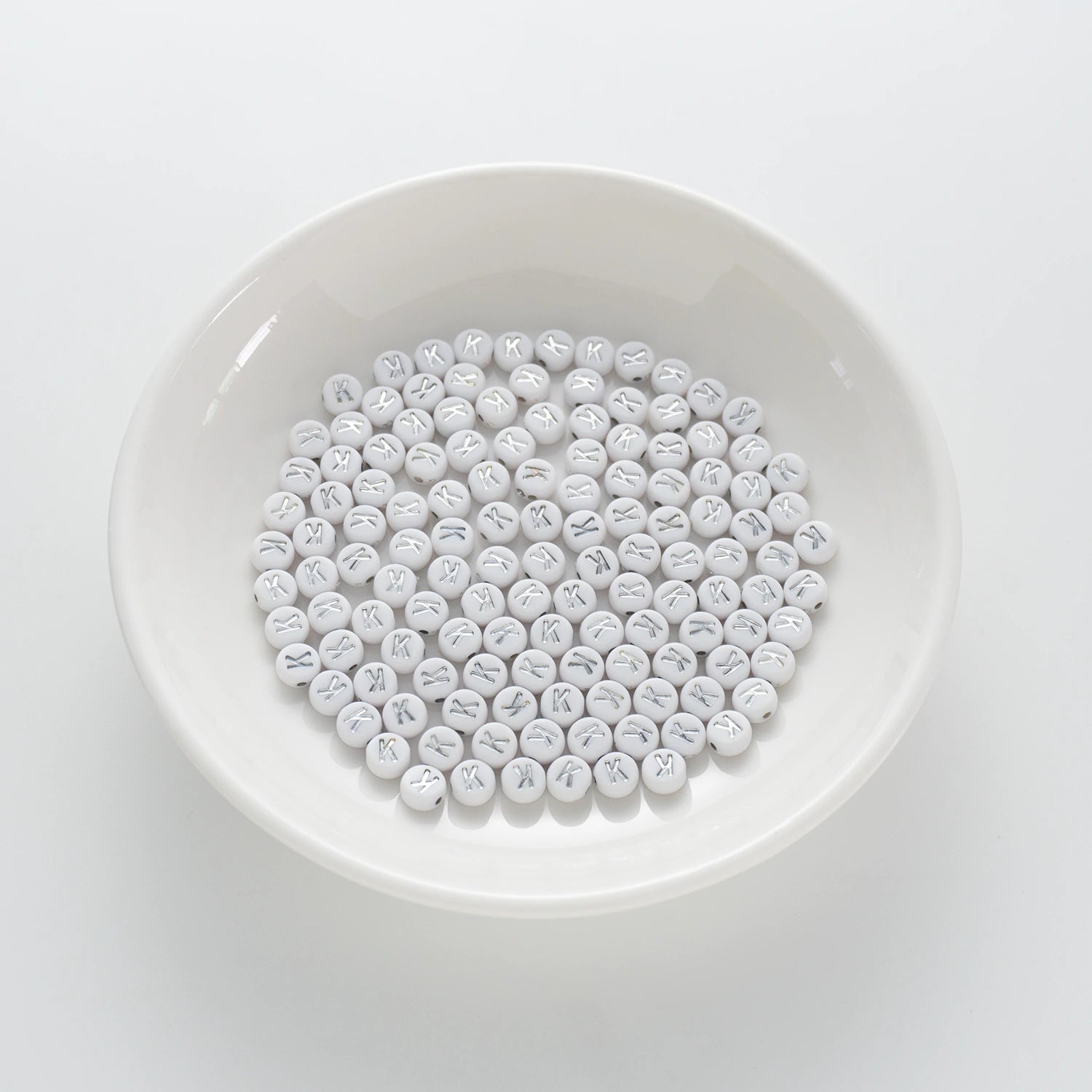BD00094-01-silver-letter-white-opaque-coin-alphabet-beads-single-k-4×7mm