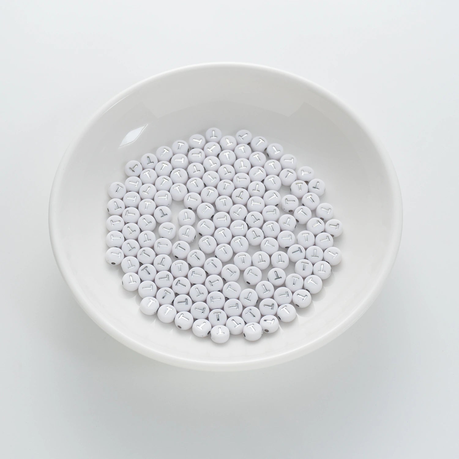 BD00103-01-silver-letter-white-opaque-coin-alphabet-beads-single-t-4×7mm