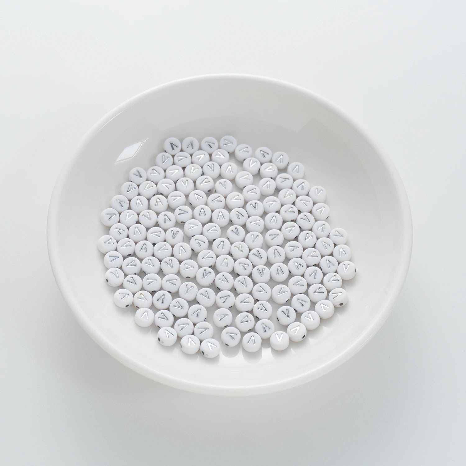 BD00105-01-silver-letter-white-opaque-coin-alphabet-beads-single-v-4×7mm