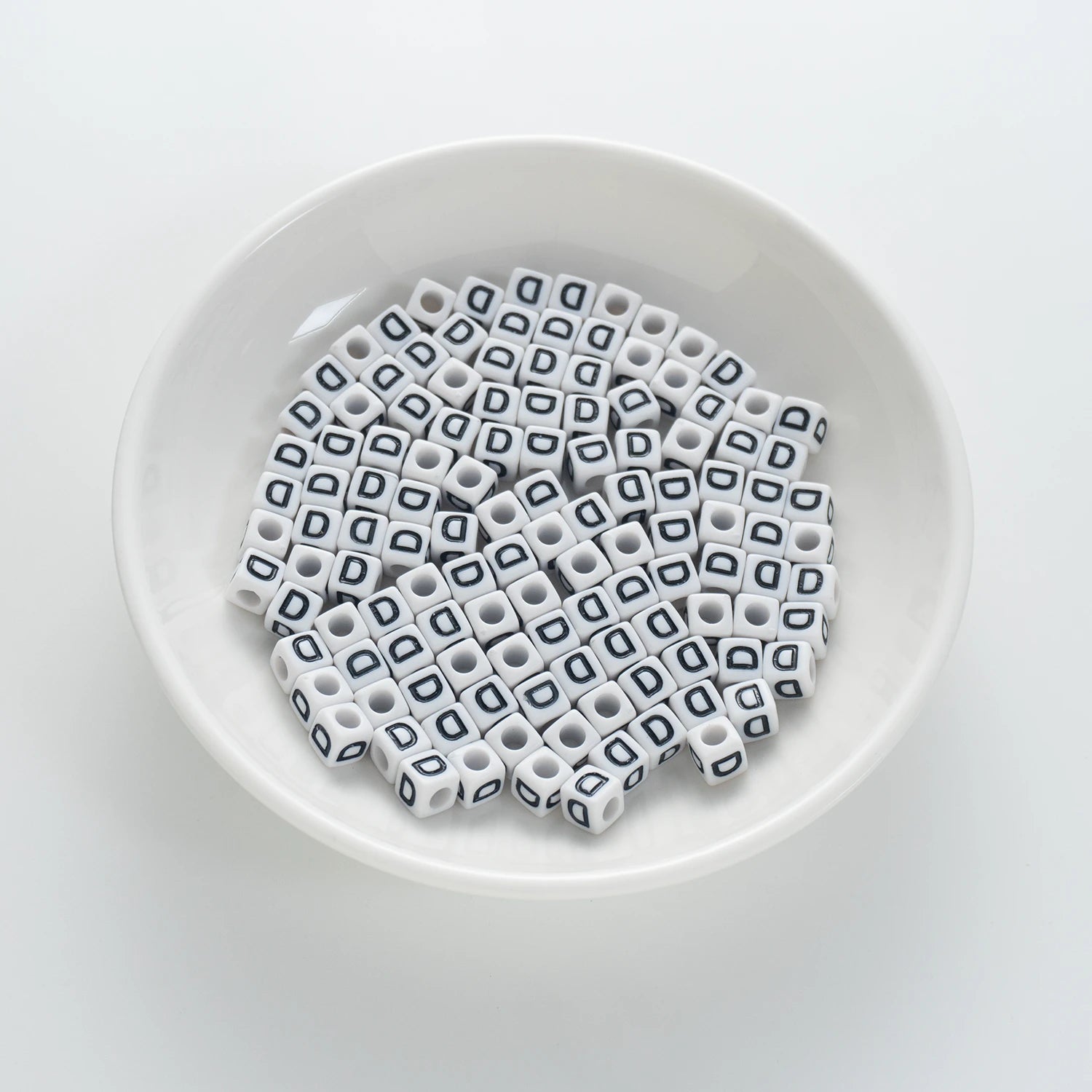 BD00115-01-black-letter-white-opaque-cube-alphabet-beads-single-d-7mm