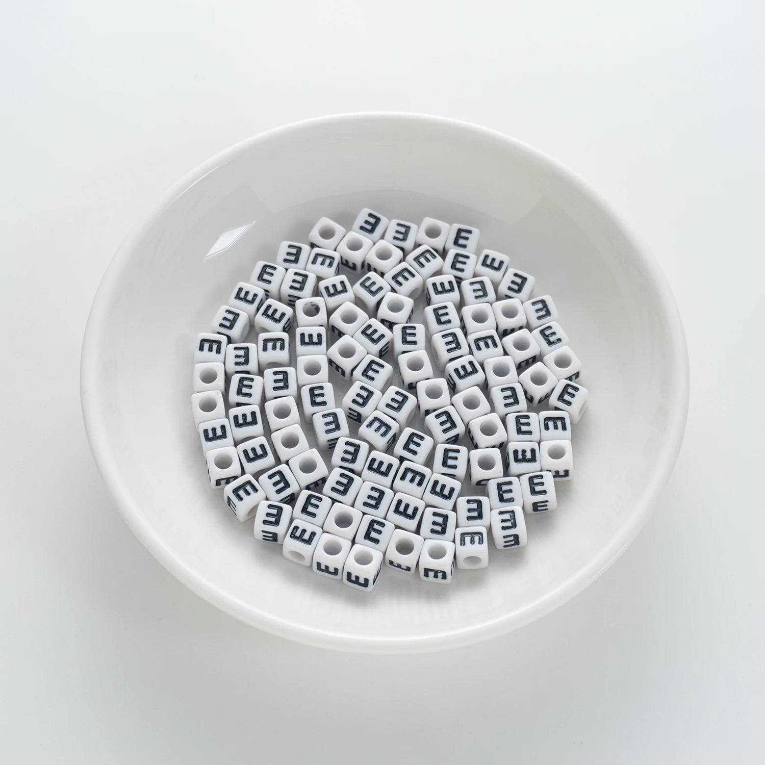 BD00116-01-black-letter-white-opaque-cube-alphabet-beads-single-e-7mm