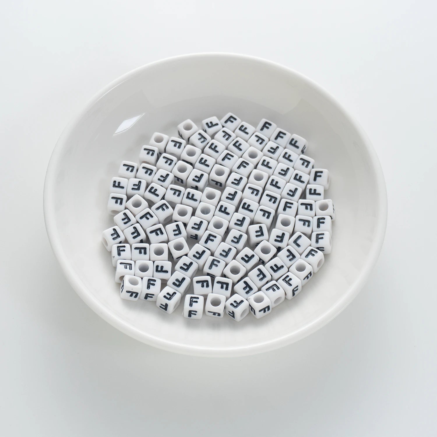 BD00117-01-black-letter-white-opaque-cube-alphabet-beads-single-f-7mm