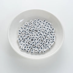 BD00117-01-black-letter-white-opaque-cube-alphabet-beads-single-f-7mm