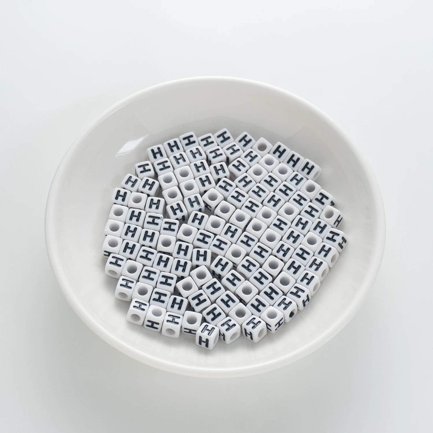 BD00119-01-black-letter-white-opaque-cube-alphabet-beads-single-h-7mm
