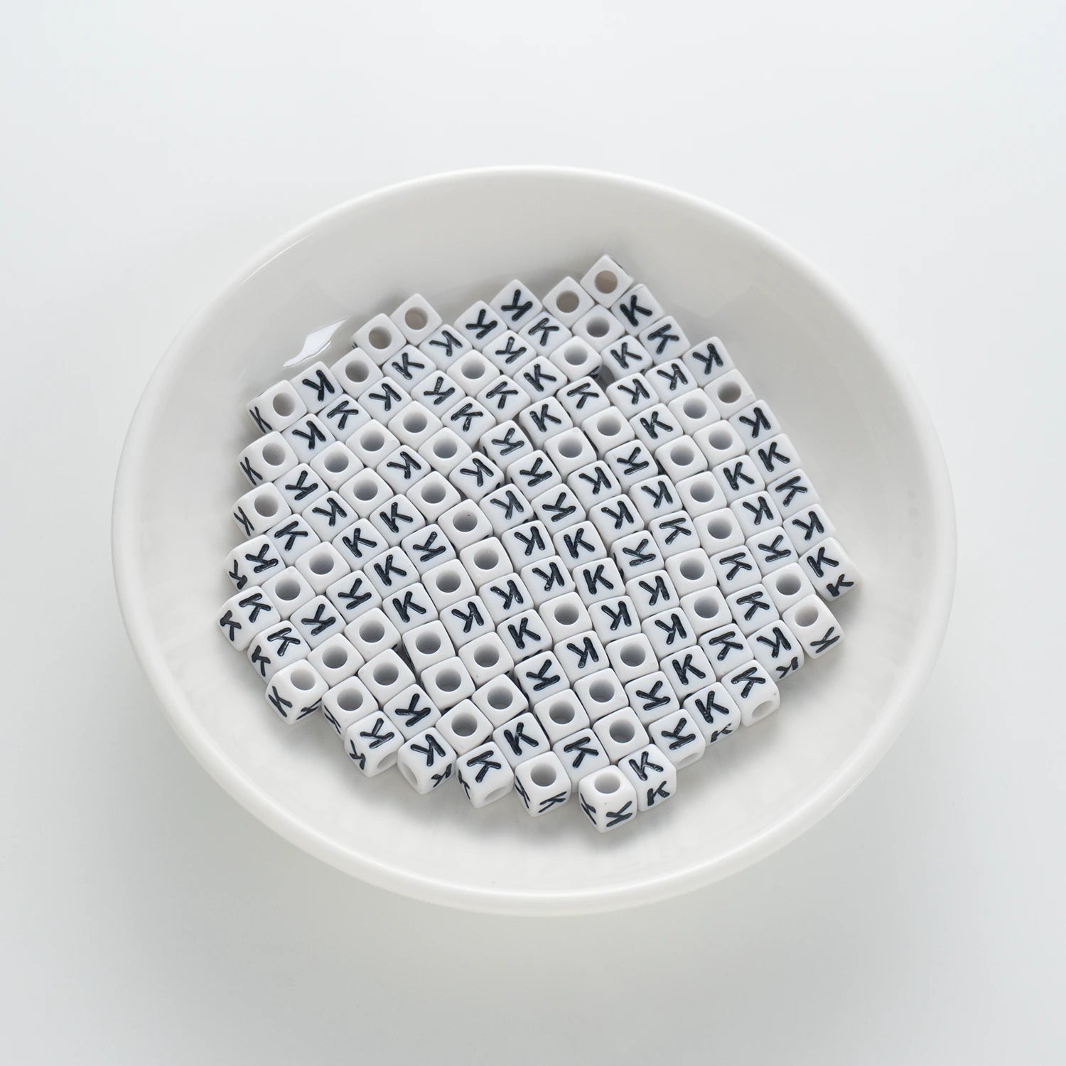 BD00122-01-black-letter-white-opaque-cube-alphabet-beads-single-k-7mm