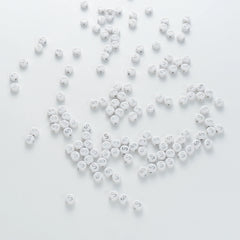 BW-00102-BD-04-silver-letter-white-opaque-coin-alphabet-beads-single-s-4×7mm