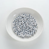 BW-00116-BD-01-black-letter-white-opaque-cube-alphabet-beads-single-e-7mm