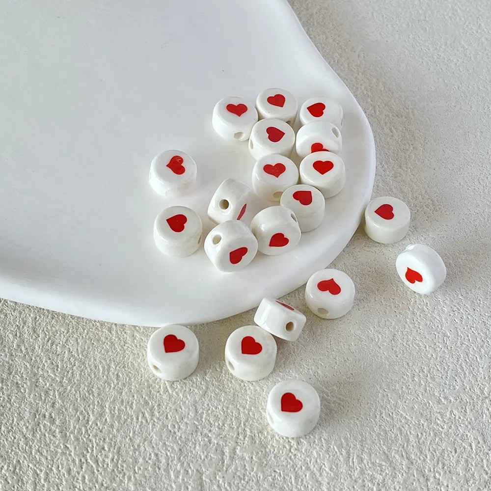 BD00017-02-red-heart-white-coin-ceramic-beads-6x10mm