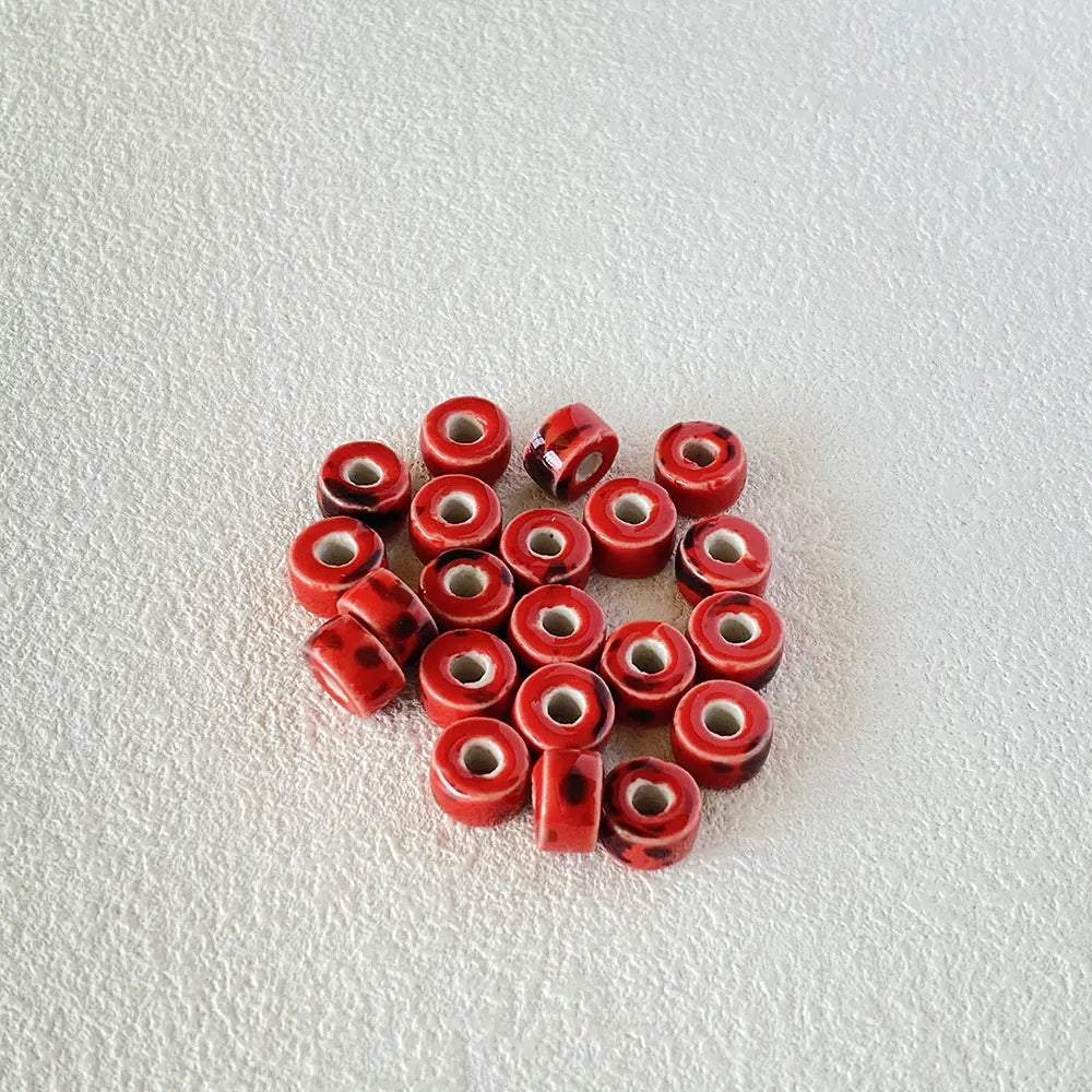 BD00018-01-red-speckle-coin-ceramic-beads-6x9mm