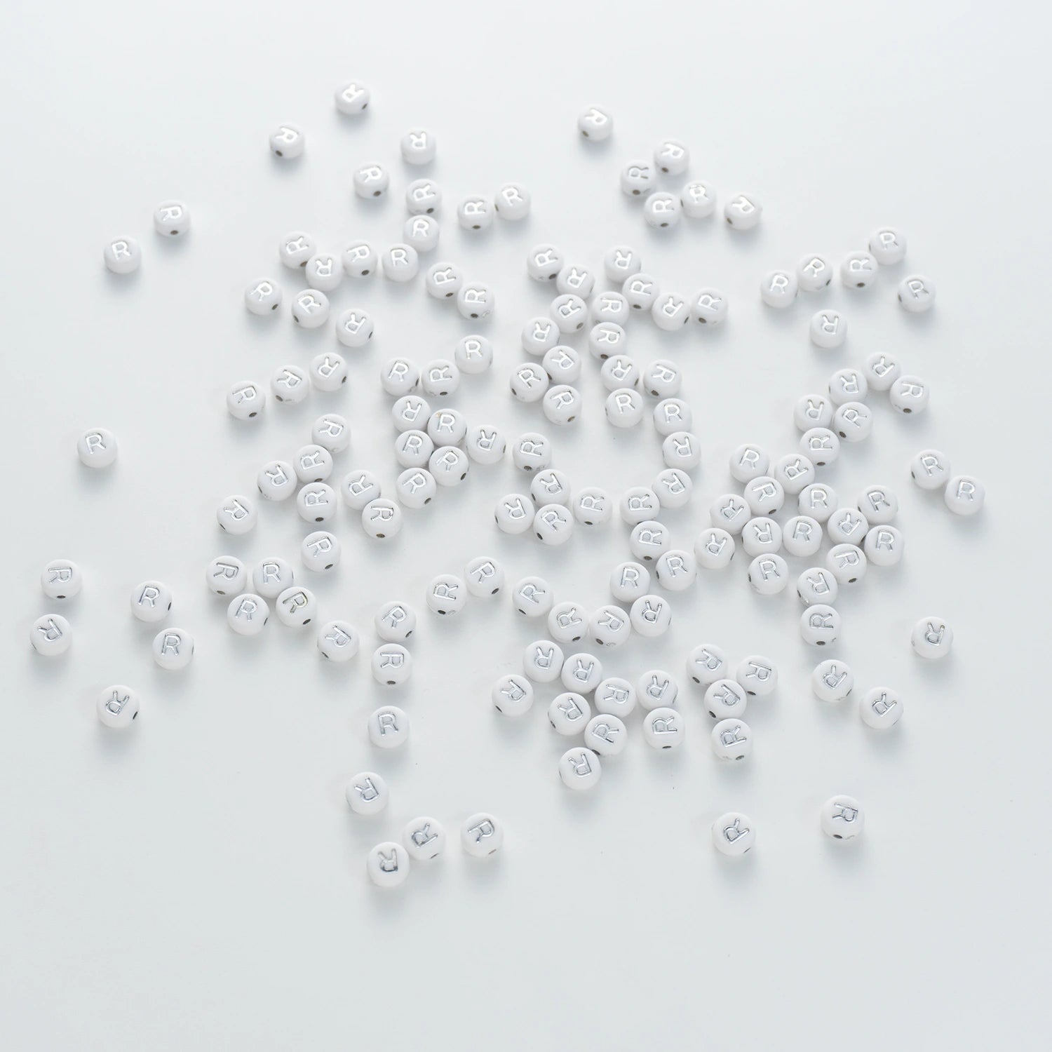 BD00101-04-silver-letter-white-opaque-coin-alphabet-beads-single-r-4×7mm