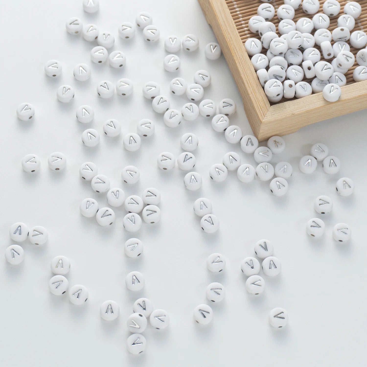 BD00105-05-silver-letter-white-opaque-coin-alphabet-beads-single-v-4×7mm