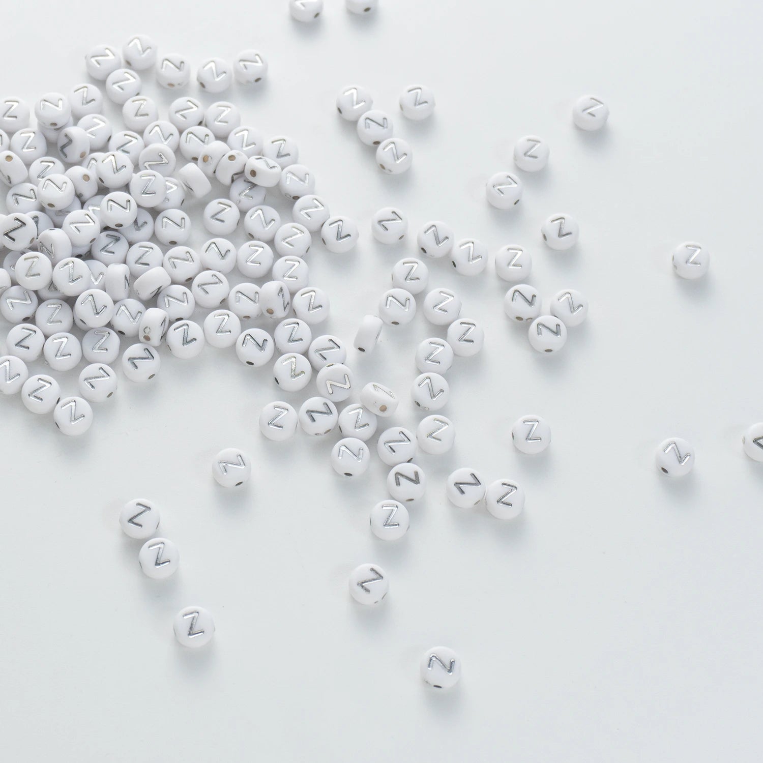 BD00109-04-silver-letter-white-opaque-coin-alphabet-beads-single-z-4×7mm