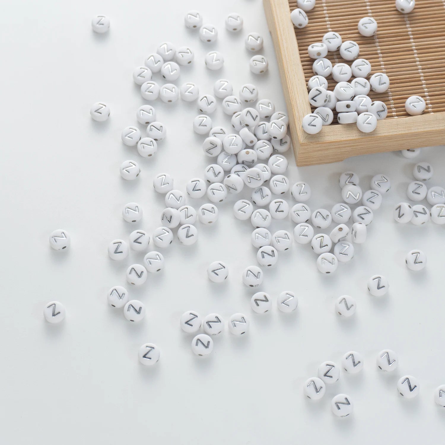 BD00109-05-silver-letter-white-opaque-coin-alphabet-beads-single-z-4×7mm