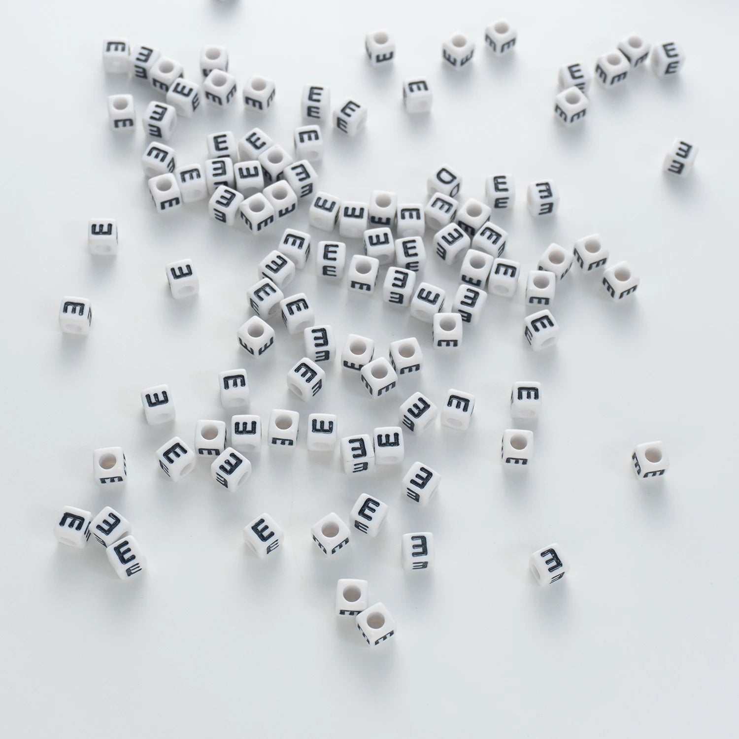 BD00116-03-black-letter-white-opaque-cube-alphabet-beads-single-e-7mm