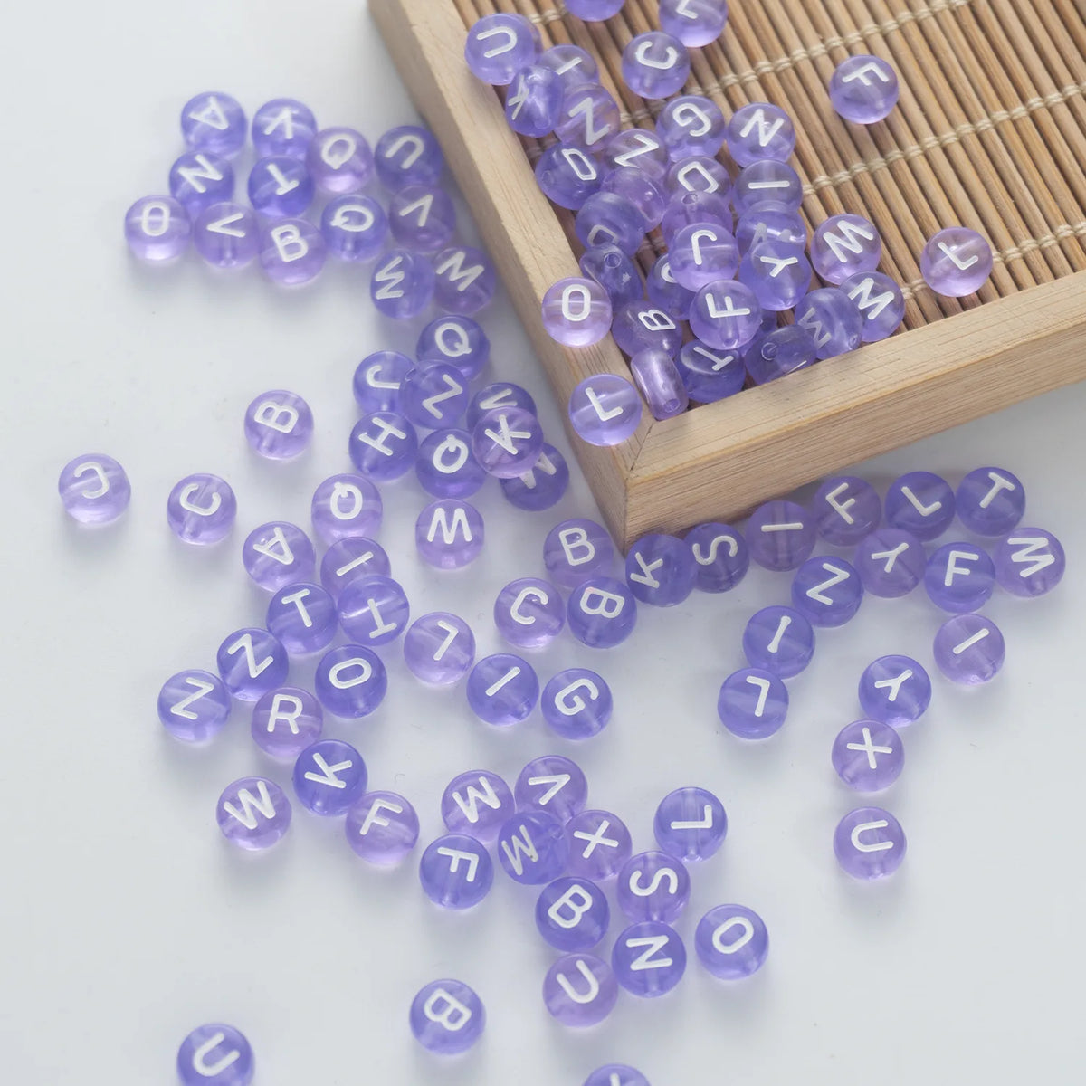 BW-00060-BD-05-white-letter-pastel-purple-transparent-coin-alphabet-beads-mix-4×7mm