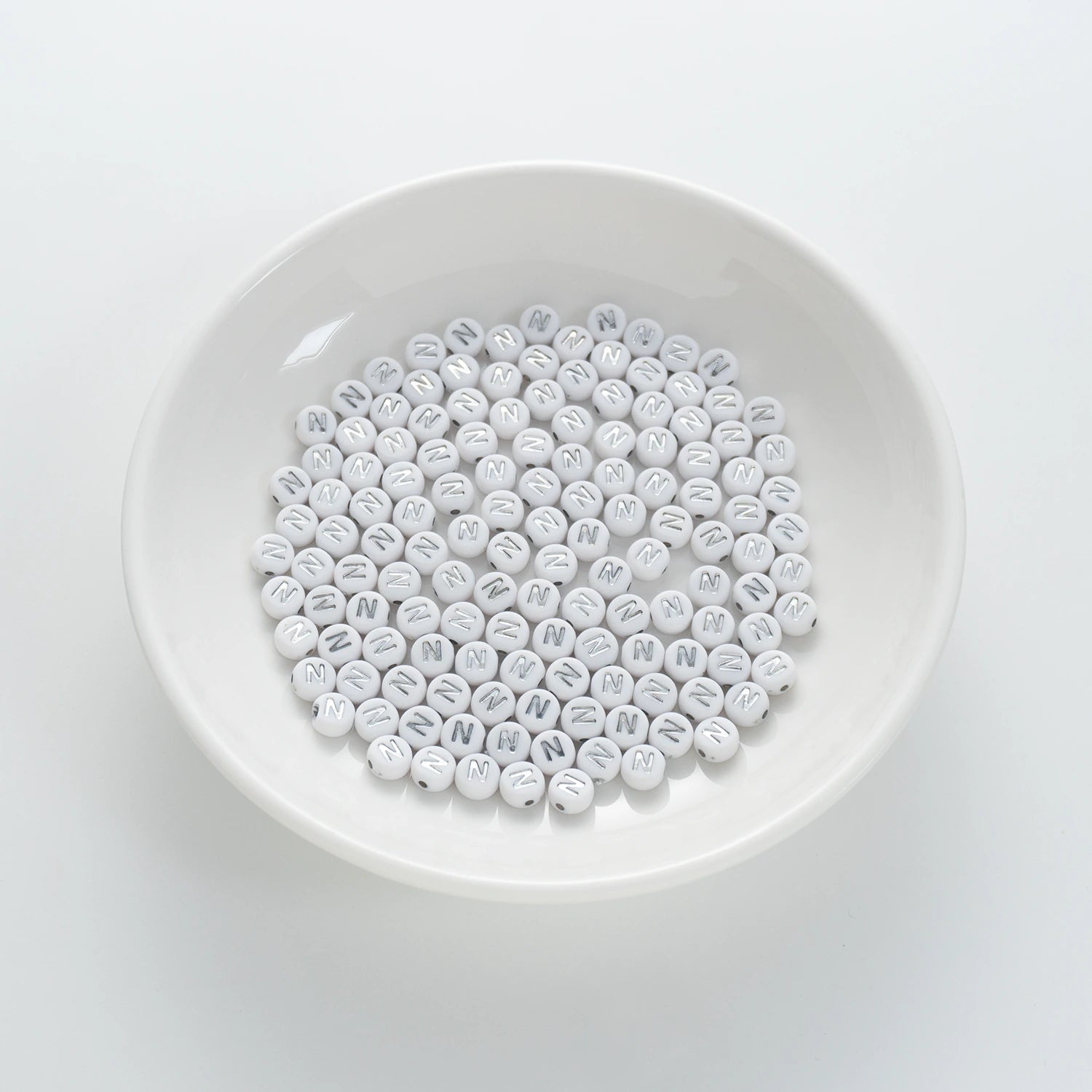BW-00097-BD-01-silver-letter-white-opaque-coin-alphabet-beads-single-n-4×7mm