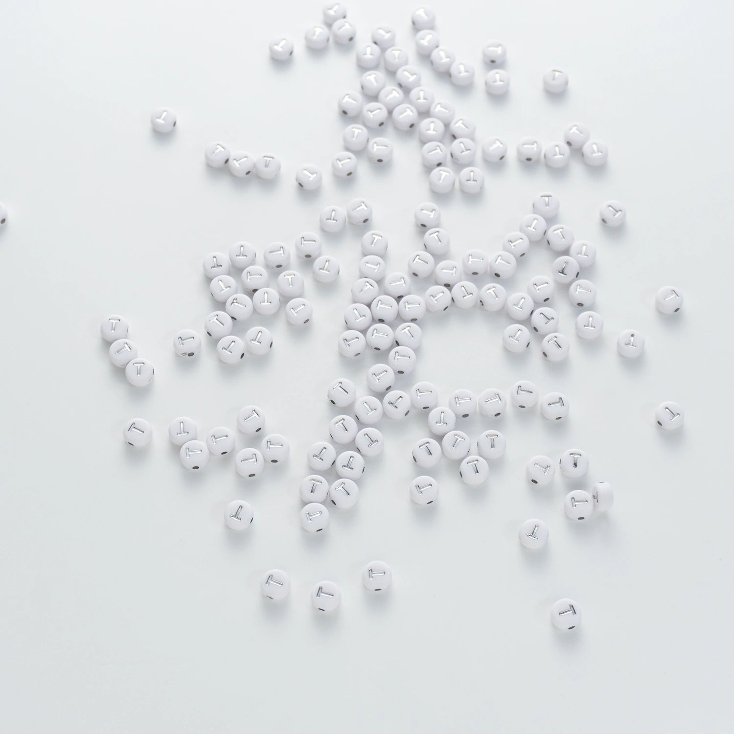 BW-00103-BD-04-silver-letter-white-opaque-coin-alphabet-beads-single-t-4×7mm