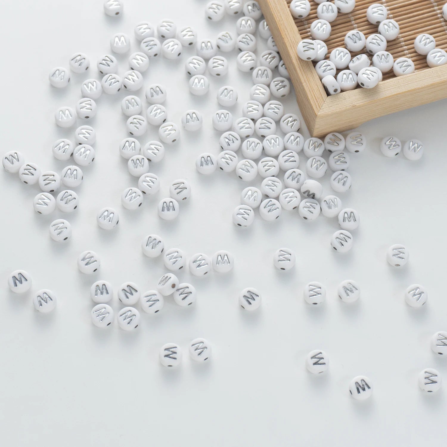 BW-00106-BD-05-silver-letter-white-opaque-coin-alphabet-beads-single-w-4×7mm