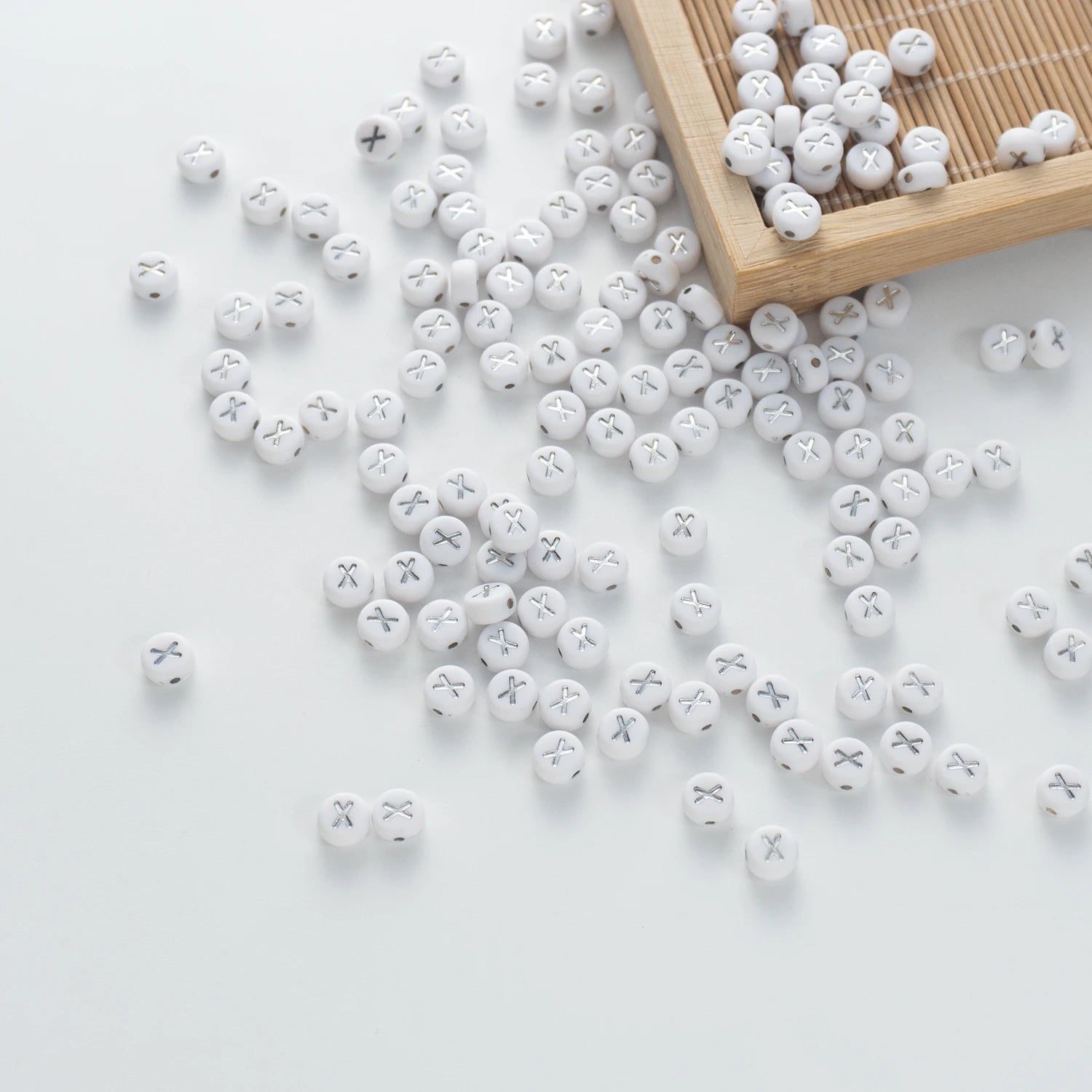 BW-00107-BD-05-silver-letter-white-opaque-coin-alphabet-beads-single-x-4×7mm