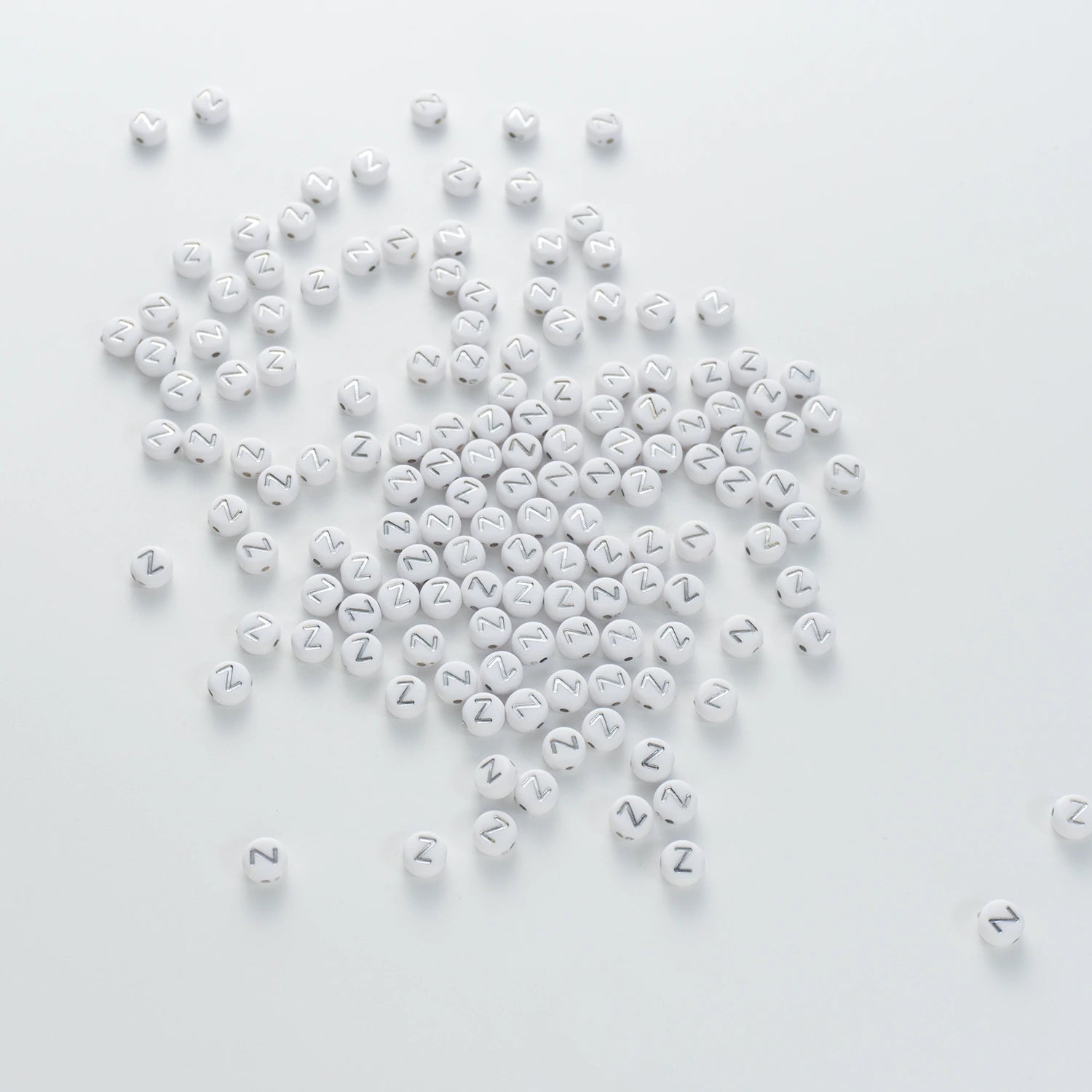 BW-00109-BD-03-silver-letter-white-opaque-coin-alphabet-beads-single-z-4×7mm