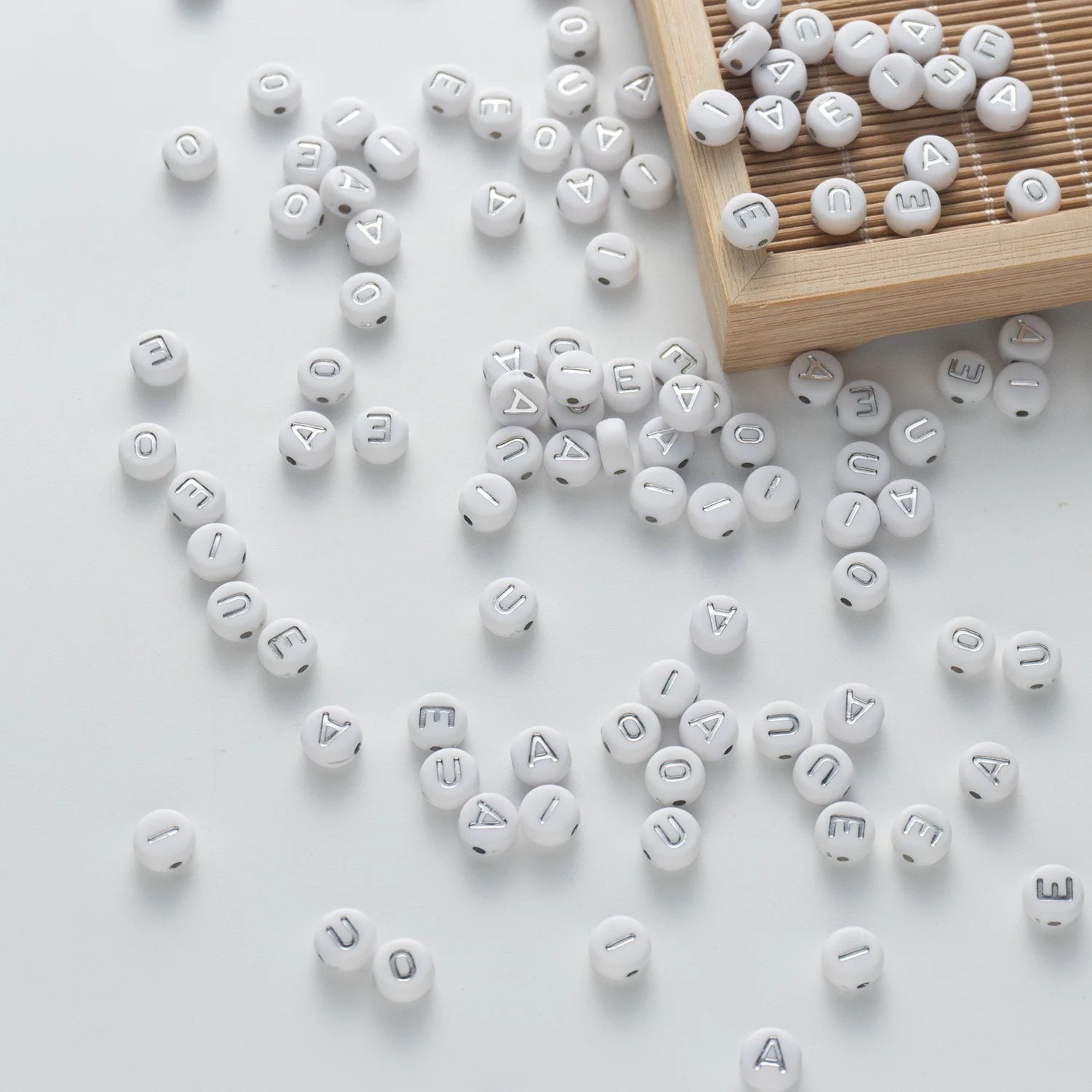 BW-00110-BD-05-silver-letter-white-opaque-coin-vowel-alphabet-beads-mix-4×7mm
